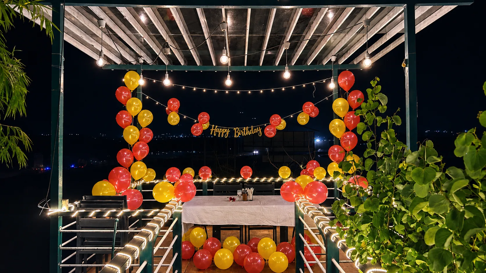 Private birthday celebration setup with balloon decor at The Herb Farm Resort, Igatpuri