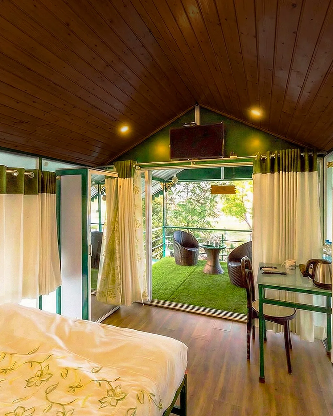 Spacious cottage interior with balcony at The Herb Farm Resort, Igatpuri