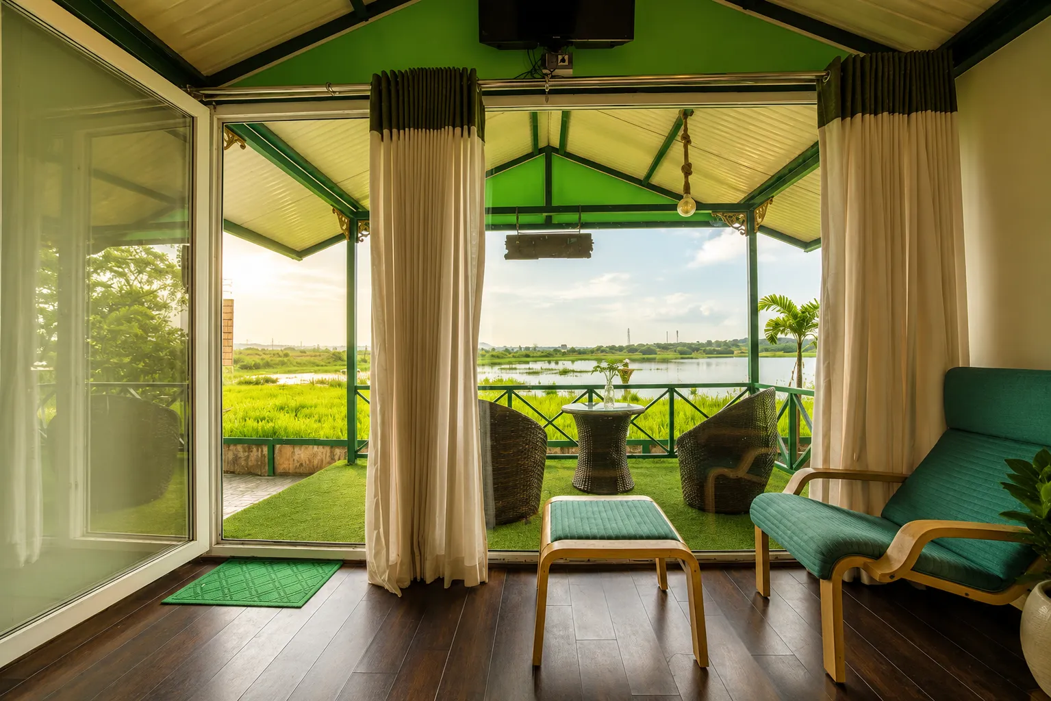 Cottage room opening to a private balcony with scenic lake views in Igatpuri