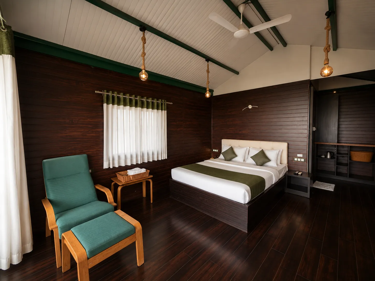 Cottage room opening to a private balcony with scenic lake views in Igatpuri